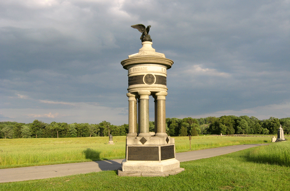 Looking east. Sickles Avenue immediately behind the monument. To its left is the bullet shape of the monument to the 7th New Jersey Infantry Regiment. The monument to New Jersey's Battery B is at the very right edge of the photo, with the Greek cross of the 139th Pennsylvania Infantry monument behind it to the left. In the right distance is Wheatfield Road and the monument to the 5th Massachusetts Battery.